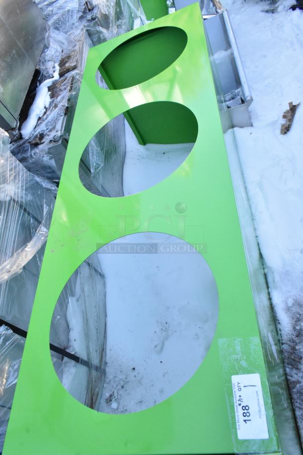 Brand new green recycling bin shell with three trash deposit holes, minor scratches, and a visible auction tag.