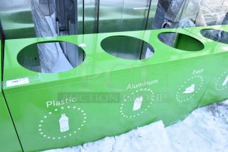 Brand new green recycling bin shell with three labeled deposit holes for plastic, aluminum, and trash. Scratch and dent condition.