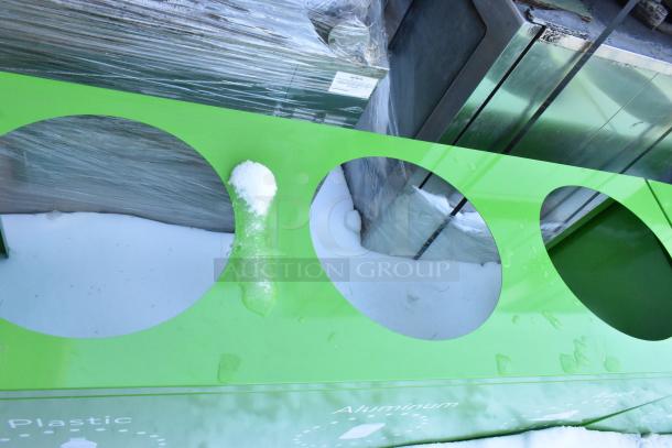 Green recycling bin shell with three trash deposit holes, brand new but with scratches and dents. Labels for plastic, aluminum.