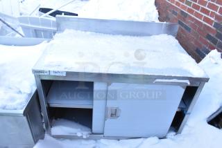 Steelton 522EBTB3048D work table, brand new, steel, 2 doors, under shelf, minor scratches, outdoor, snow-covered surface.