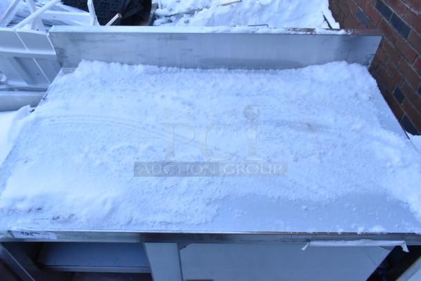 Steelton 522EBTB3048D work table, brand new, with scratches and dents, features 2 doors, under shelf; snowy surface.