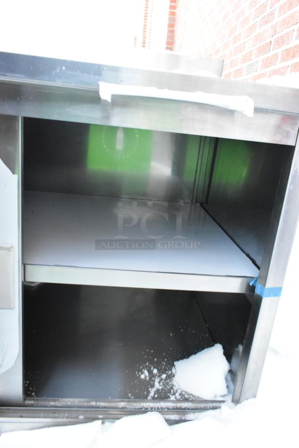 Brand new Steelton Work Table 522EBTB3048D, features two doors, under shelf, minor scratches, stainless steel.