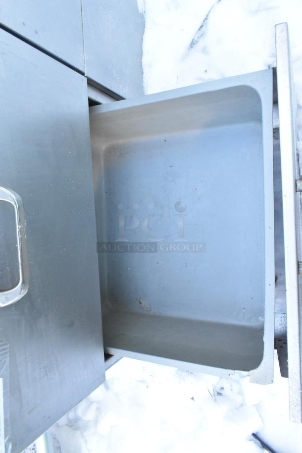 Stainless steel work table with 4 spacious drawers and backsplash. Features sturdy construction and a clean finish.