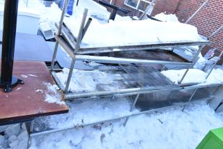 Four metal overshelves outdoors in snowy condition, various sizes and designs, used state, suitable for storage.
