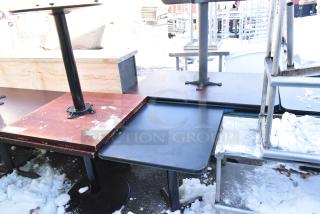 Three dining height tables in varied conditions, featuring metal bases and wooden tops with some visible wear.