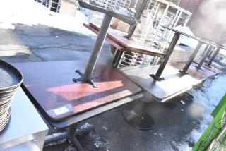 Eight dining height tables, wooden tops, metal bases, used condition, stacked outdoors, sale tag shows "195."