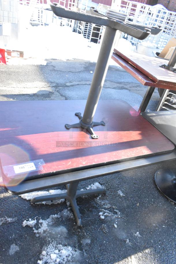 8 various dining height tables with metal pedestal bases, some with wood surfaces. Visible tag indicates item 195.