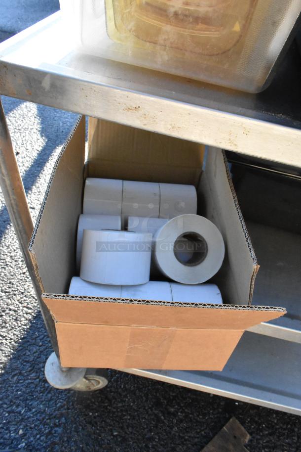 3-tier cart on commercial casters with poly bins, colander, and cardboard box containing paper rolls, in used condition.