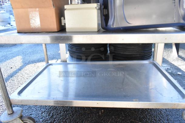 3-tier stainless steel cart on commercial casters, includes colander and poly drop-in bins. Visible cardboard box and containers.