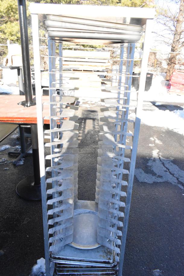 Metal pan transport rack with multiple shelves on robust commercial casters. Suitable for kitchen or catering use.