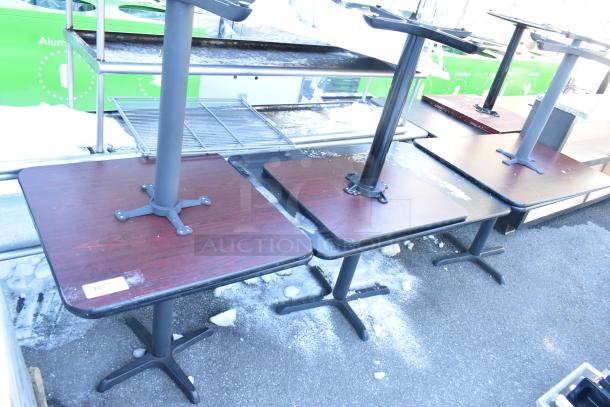 Six dining-height square tables, dark wood tops, metal pedestal bases, fair condition, label "203" visible on one.