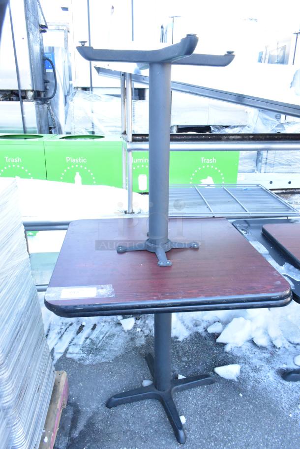 Dining height table with metal base and wooden top, minor wear. Auction includes 6 tables. Marking indicates lot number.