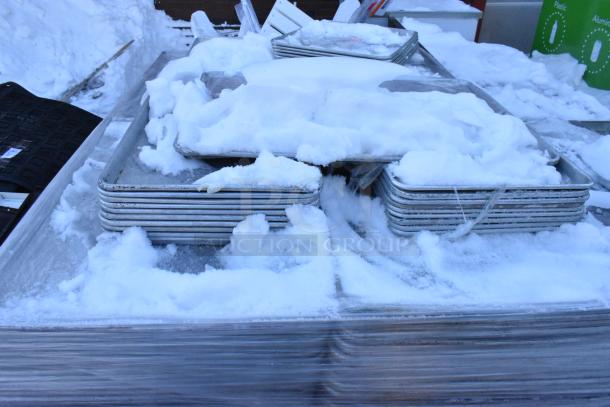 392 metal baking pans in snow; includes full and half sizes. Pans appear stacked and wrapped, suitable for bulk purchase.