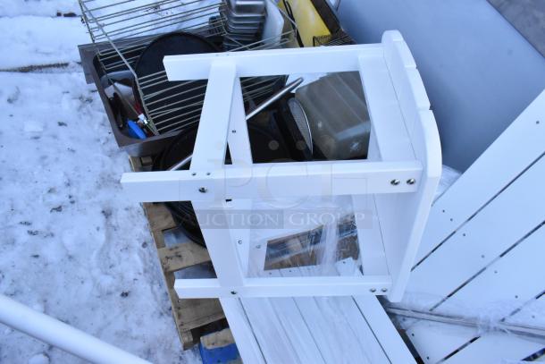 Six assorted items including white chairs, an end table, and mixing paddles, in good condition, on a snowy surface.