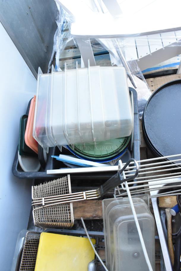 Pallet lot with serving trays, poly drop-in bins, fry baskets, and mixed kitchen items. Various colors and sizes.