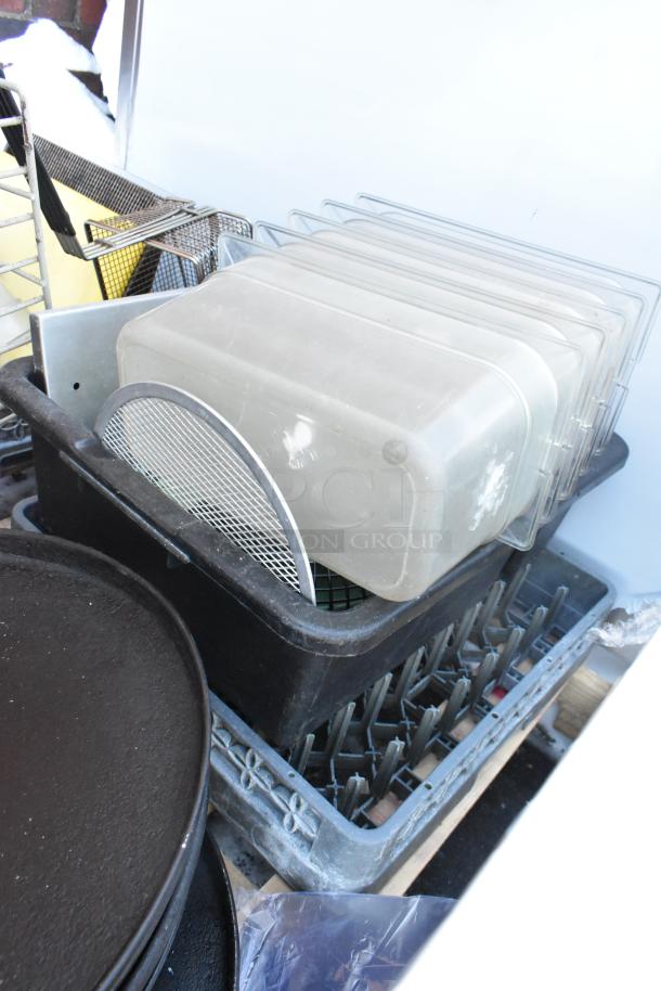 Pallet lot with serving trays, poly drop-in bins, and a fry basket. Items stacked in good condition, ideal for catering.