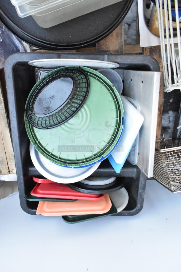 Pallet lot with serving trays, poly drop-in bins, and a fry basket. Various colors and sizes. Mixed condition.