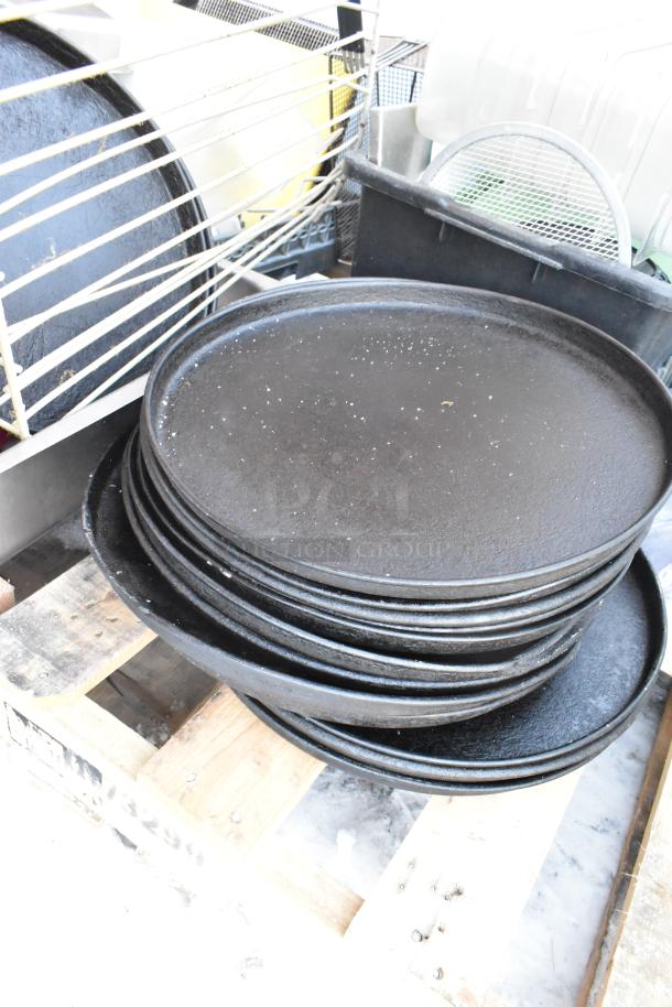 Pallet lot with black serving trays, poly drop-in bins, and a fry basket; varied condition, ideal for kitchen use.
