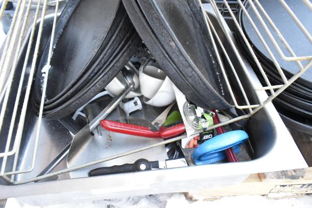 Pallet lot with serving trays, poly drop-in bins, and a fry basket. Items appear used, diverse kitchenware collection.