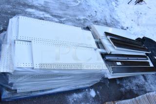 Pallet lot of various shelves and items, including perforated white metal panels. Items appear in used condition.