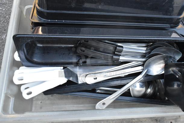 Pallet lot with poly bins, serving spoons, spatulas, and ingredient bin. Various kitchen items in good condition.