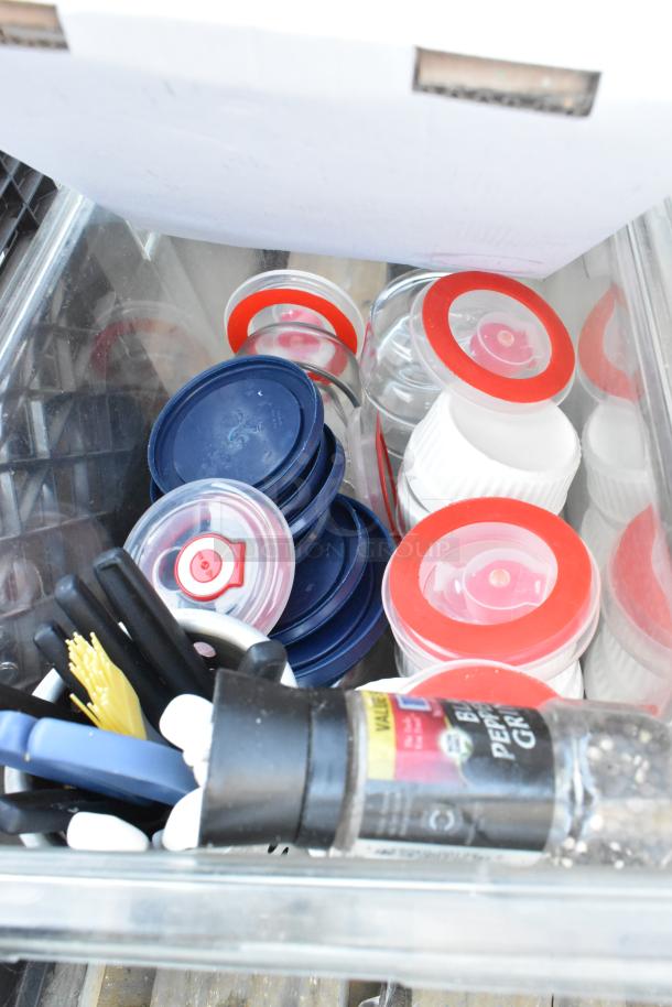 Pallet lot with ingredient bin, poly bins, serving spoons, spatulas, and assorted lids. Items in varied condition.