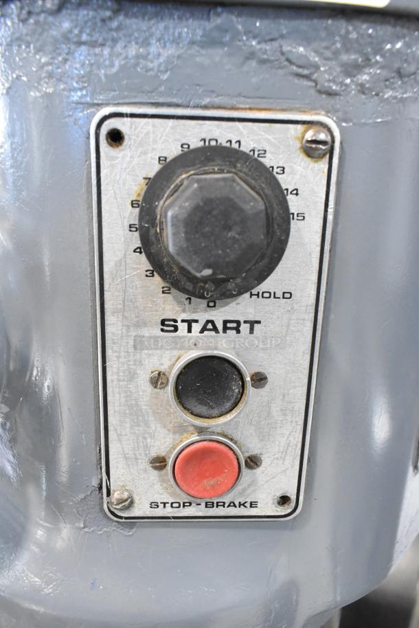 Hobart H 600T controls with start button, speed dial, and stop-brake button; commercial 60-quart dough mixer.