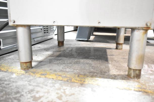 Hobart 5614 Commercial Meat Saw base, showing sturdy metal legs and floor surface, 200-230V, 3 Phase, floor-style design.