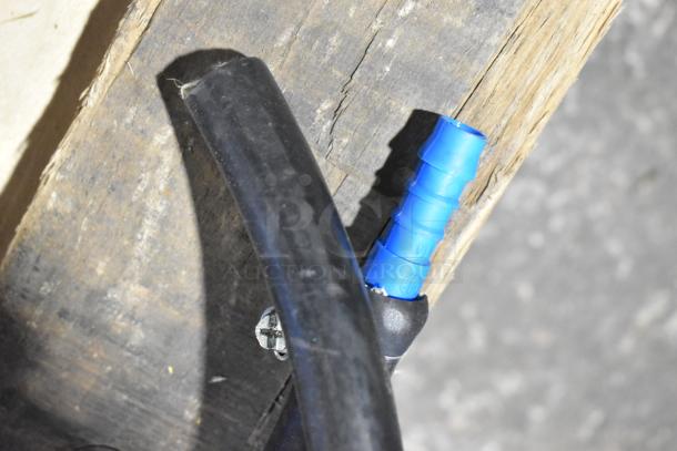 Close-up image of a power cord with a blue connector on a wooden surface.