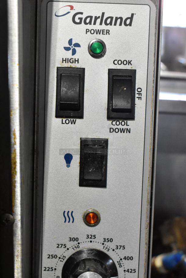 Garland Master 200 oven control panel with thermostat, fan settings, and light indicator. Shows temperature dial and switches.