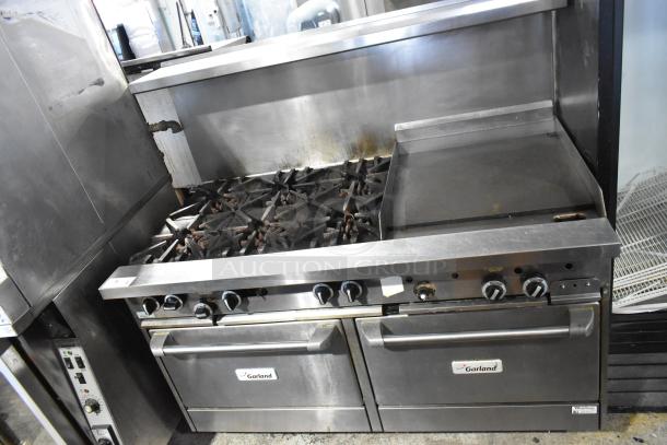 Garland commercial gas range with 6 burners, flat top, 2 ovens, over shelf, and back splash. Used condition.