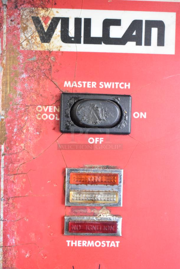 Vulcan SG4D-1 oven controls with master switch, thermostat, and indicator lights. Rust and wear visible on control panel.