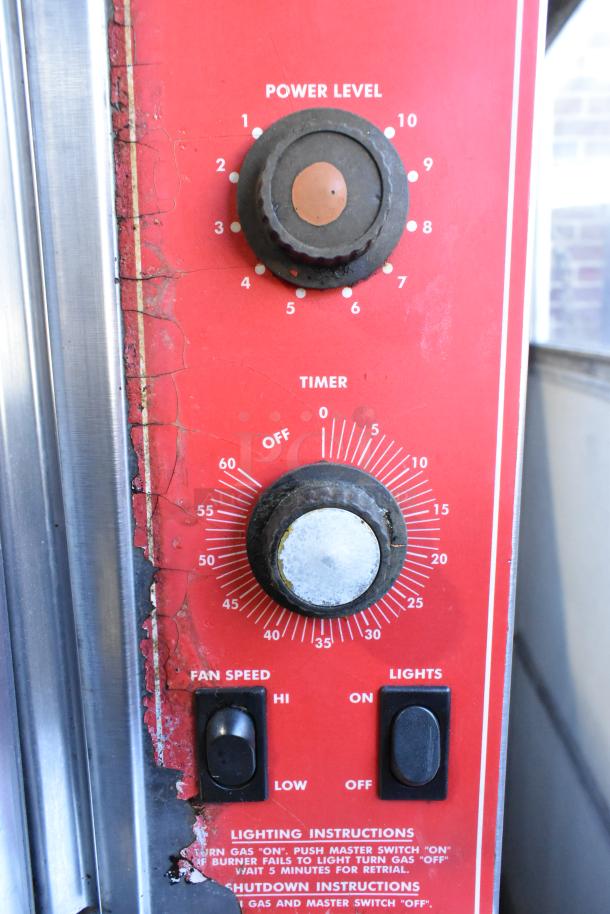 Close-up of Vulcan SG4D-1 oven controls showing power level and timer knobs, fan speed and lights switches, and lighting instructions.
