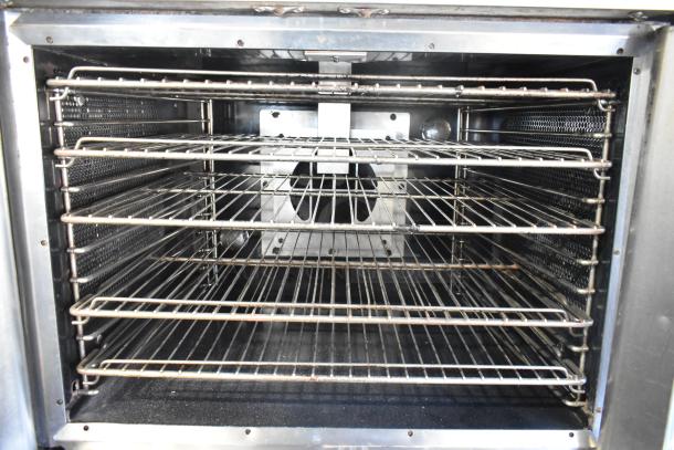 Vulcan SG4D-1 convection oven interior with multiple metal racks, view-through doors, and thermostatic controls.