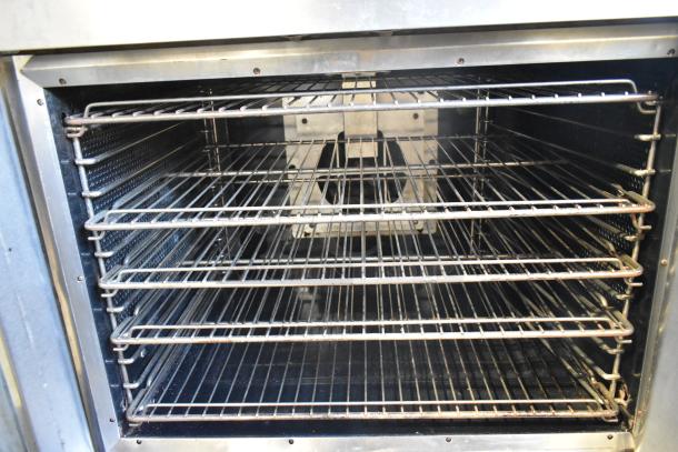 Vulcan SG4D-1 commercial convection oven interior with metal racks, view-through doors, and thermostatic controls.