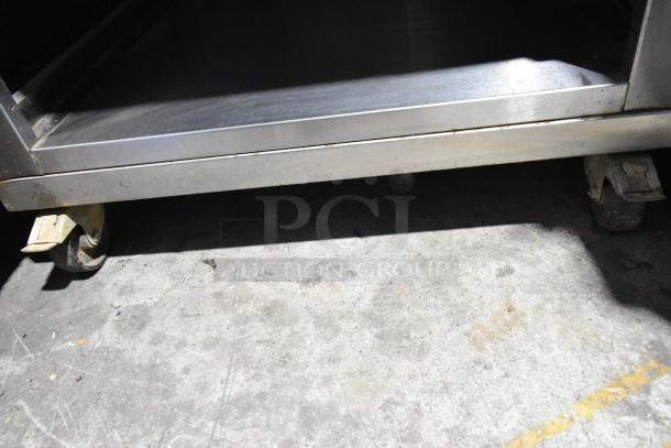 Mono FG180C-UZ52 BX electric convection oven, stainless steel finish, 308V, 3 phase. Good condition, on caster wheels.