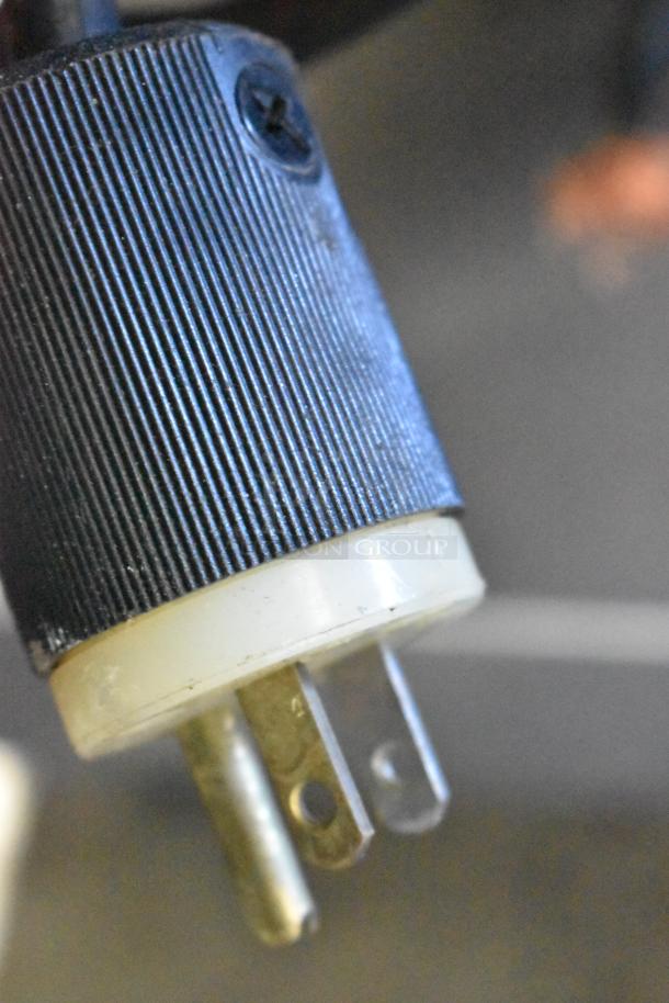 Close-up of a three-pronged plug for a Mono FG180C-UZ52 convection oven, showing electrical connector detail.