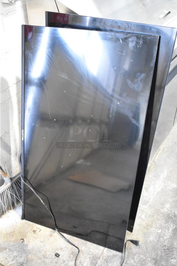 Three flat-screen televisions, including Sceptre TGTV83BF, stacked against a wall. Buyer must pick up.