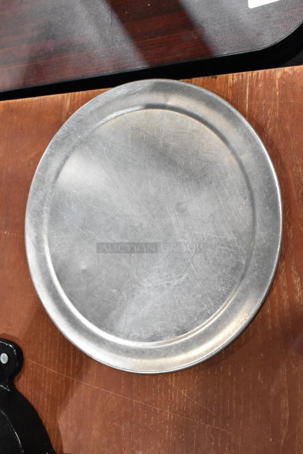 Round metal baking sheet, lightly scratched, showing moderate wear, part of 51 mixed auction items.