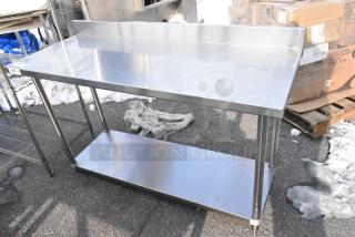 Regency 600TSB2460S stainless steel table with under shelf and backsplash, excellent condition, ideal for kitchen use.