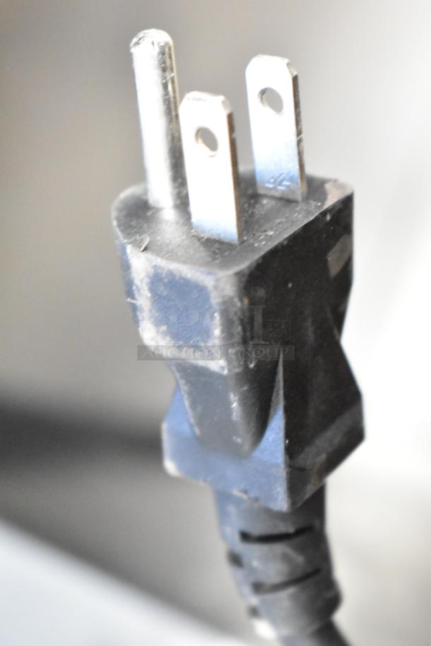 Close-up image of a power plug for the Magic Chef HMDR310SE Mini Cooler. Brand new with slight scratches/dents.