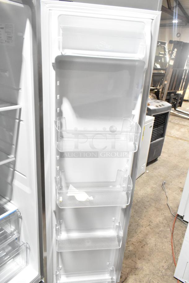 BRAND NEW Frigidaire FRSS2623ASN fridge door interior view, adjustable shelves, clean, minor scratches.