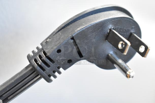Close-up of black power plug for the Frigidaire FRSS2623ASN fridge. Features include a grounded three-prong design.