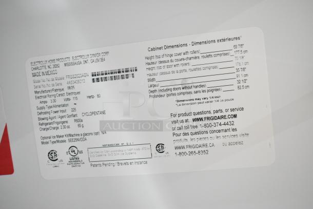 Frigidaire FRSS2623ASN label showing model, dimensions, and manufacturing details; new condition with minor scratches.