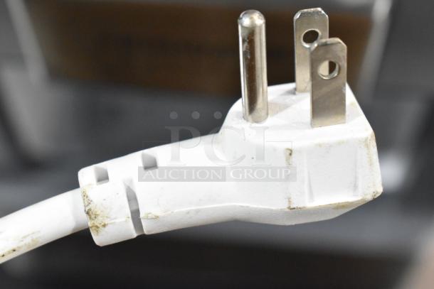 Close-up of a white plug with a standard 3-prong design, showing slight dirt marks. Plug for Frigidaire Gallery EFIC201 Ice Maker.