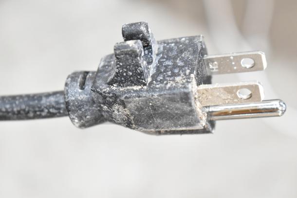Close-up of a worn power plug for the Hessaire MC37V Mobile Evaporative Cooler, showing visible wear and dirt.