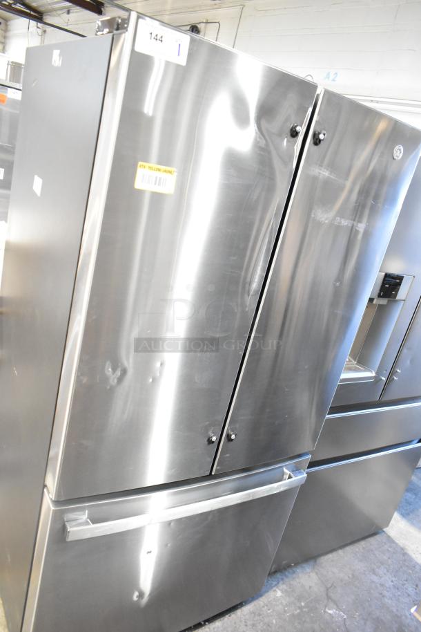 Brand new GE GNE27JYMYFFS French door refrigerator with drawer freezer, minor dents, model label visible, 115V, 1 Phase.