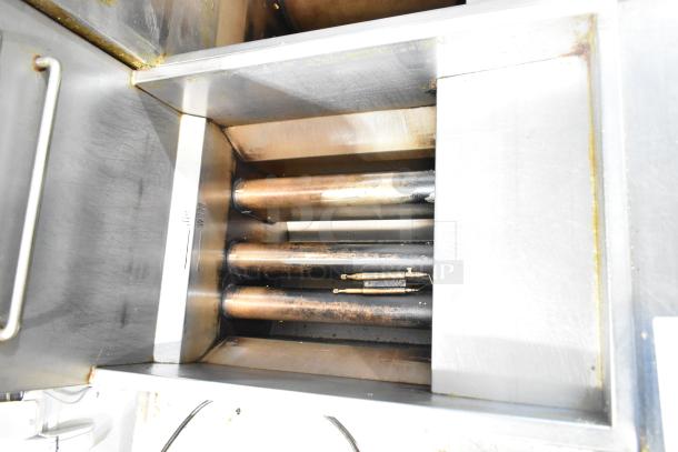 Avantco F3-N commercial floor style natural gas fryer, 90,000 BTU, showing interior heating elements, well-maintained condition.