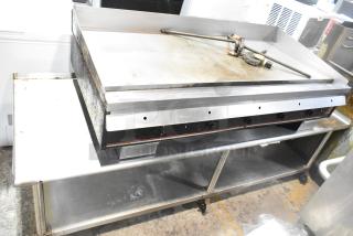 Wolf Regency commercial countertop flat top griddle with thermostatic controls, equipment stand, and commercial casters. Used condition.