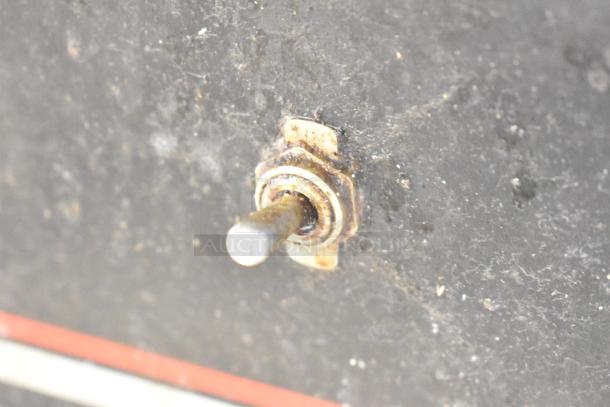 Switch on the Wolf Regency griddle's equipment stand, displaying signs of wear.